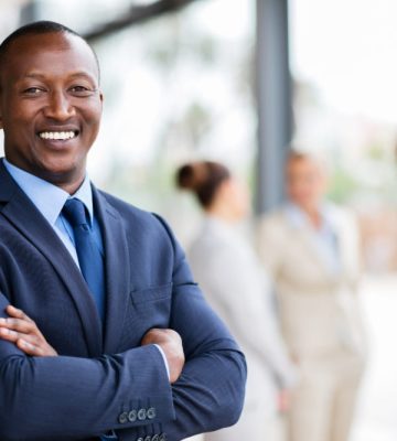 portrait of successful african office worker with arms crossed